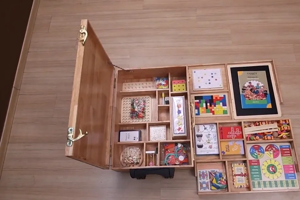Top-down view of the open Vayofit Wellness Kit showing its full set of screen-free games, puzzles and activity cards